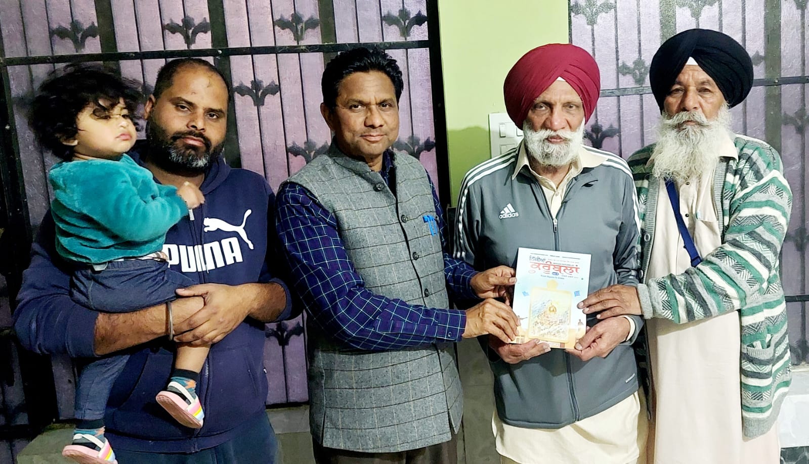 Children's literature writer Baljinder Mann presenting his book 'Mahilpur's Football World' to the certified translator of Canada